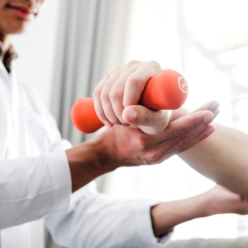 Physiotherapist,Man,Giving,Exercise,With,Dumbbell,Treatment,About,Arm,And